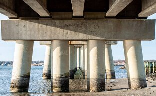 under Under The Ponquogue Bridge. This bridge crosses over the Shinnecock Bay in Hampton Bays on Long Island. It connects Hampton Bays to the eastern end of...