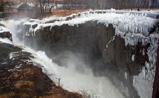 passaic-river Frozen mist from the Great Falls of the Passaic River of Paterson, New Jersey. The Great Falls of the Passaic River is a prominent waterfall, 77 feet (23 m)...